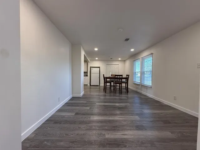 a kitchen with granite countertop a stove and white cabinets