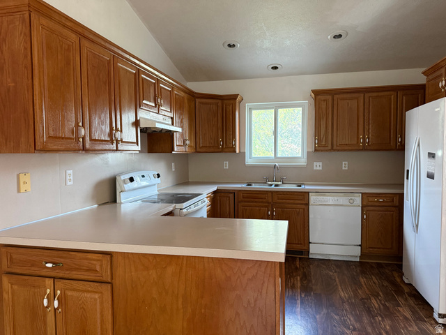 44 Wapiti Loop Hyrum, UT 84319 - Photo 9 of 18 Kitchen featuring extensive wood cabinetry, laminate countertops, wood-finish flooring, a stainless-steel sink, and recessed lighting