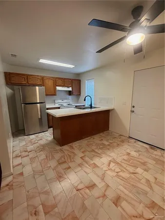 a kitchen with stainless steel appliances a sink stove and refrigerator