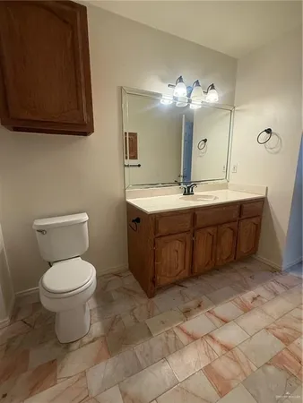 a bathroom with a toilet sink and mirror