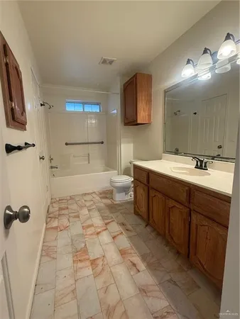 a spacious bathroom with a sink mirror and shower