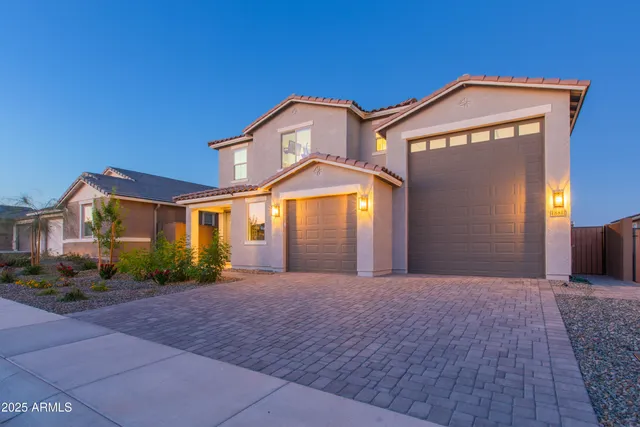 a front view of a house with a yard and garage