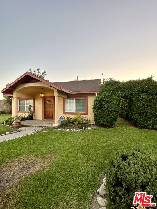 Undisclosed Address Azusa, CA 91702 - Photo 1 of 31 a front view of a house with a garden