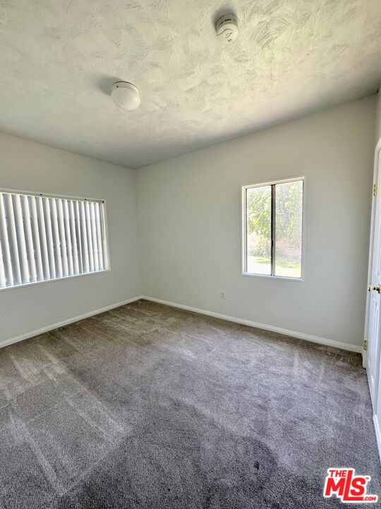 Undisclosed Address Azusa, CA 91702 - Photo 14 of 31 an empty room with a chandeliers fan