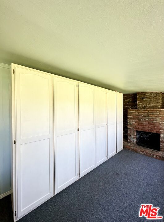 Undisclosed Address Azusa, CA 91702 - Photo 27 of 31 a view of an empty room with a fireplace and a window
