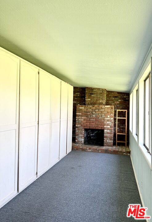 Undisclosed Address Azusa, CA 91702 - Photo 29 of 31 an empty room with a fireplace and window
