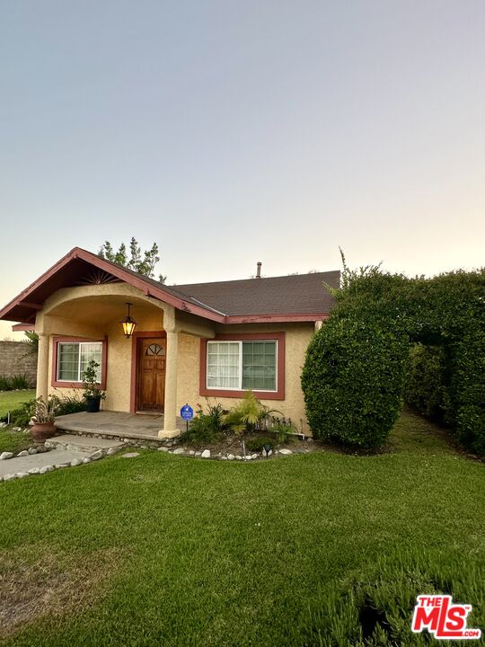 Undisclosed Address Azusa, CA 91702 - Photo 30 of 31 a front view of a house with a yard and garage