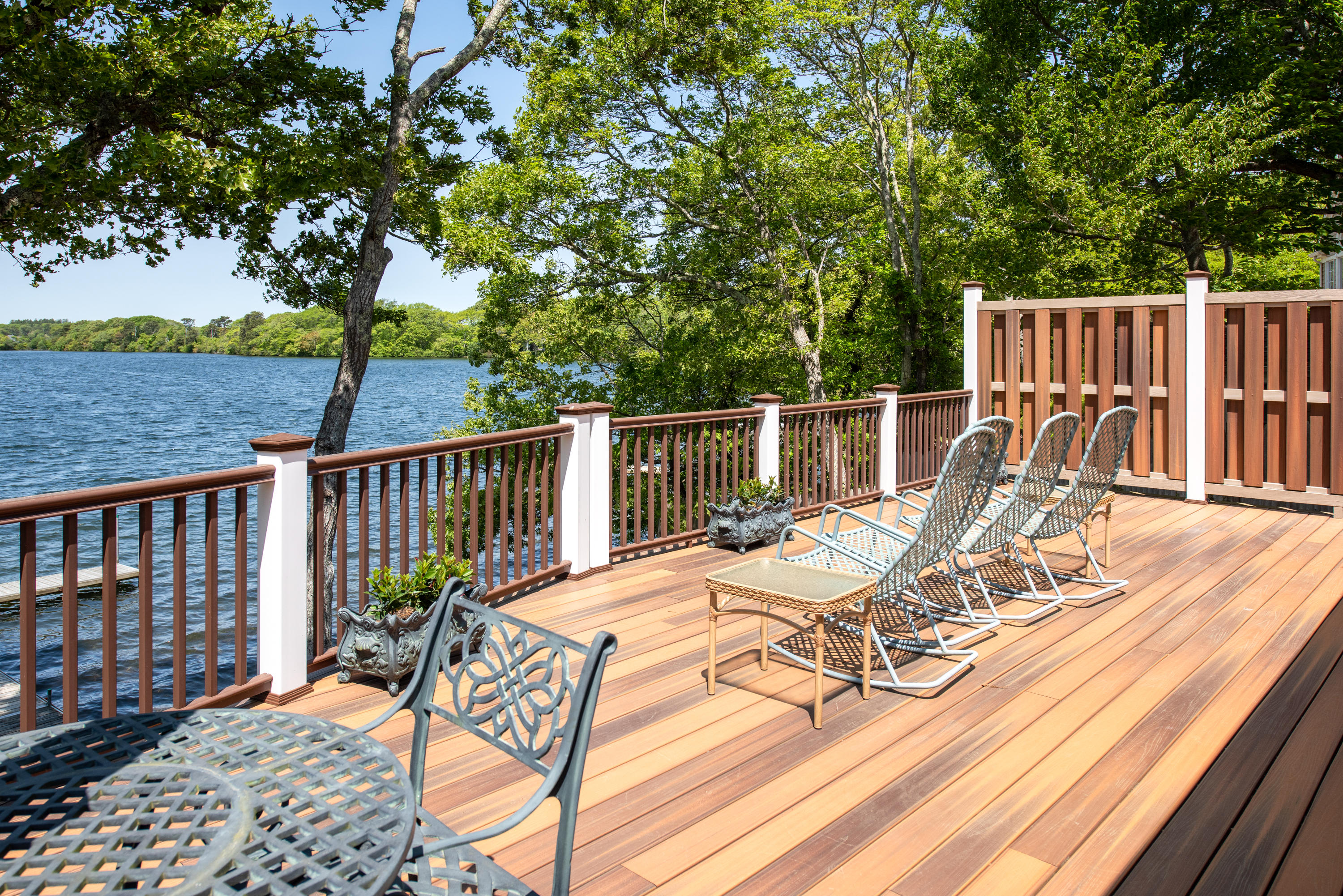 326 Holly Point Road Centerville, MA 02632 - Photo 16 of 30 a view of a balcony with chairs and wooden floor