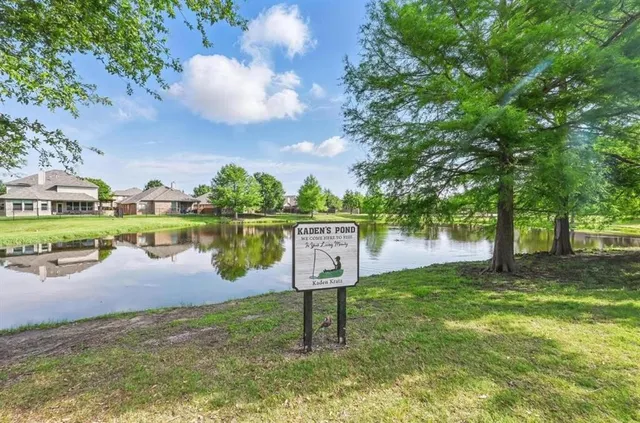 an aerial view of a house with garden space and a street view
