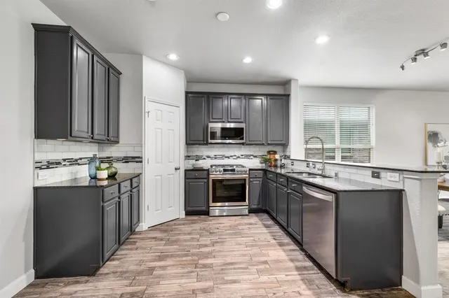 an aerial view of residential houses with outdoor space and a street view