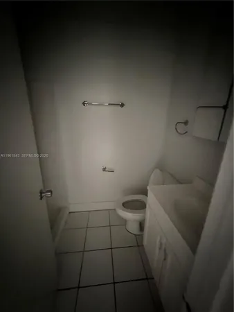 a bathroom with a toilet and a rug