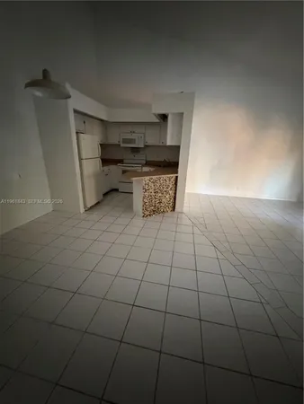 a kitchen with a sink and a refrigerator