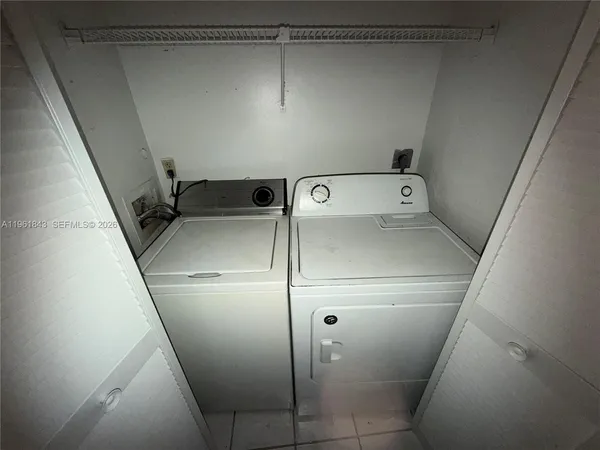 a kitchen with a refrigerator a stove top oven and cabinets