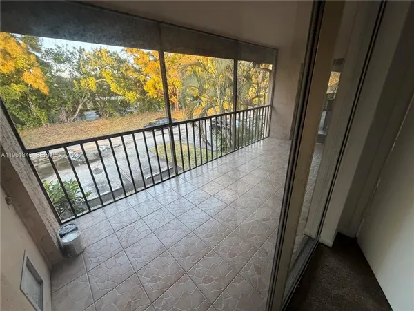 a view of a balcony with wooden floor