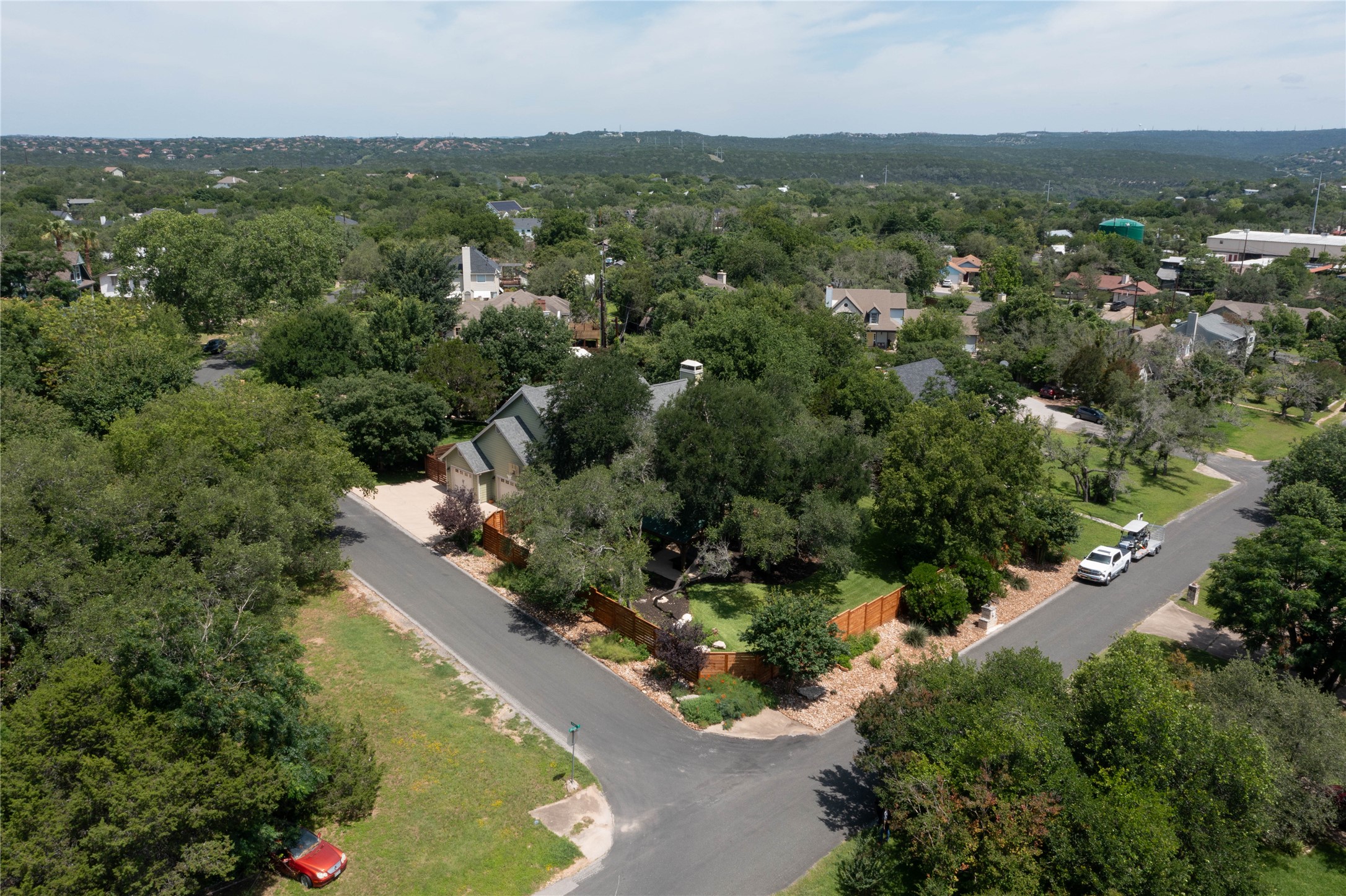 1204 Orlando Road Austin, TX 78733 - Photo 2 of 40 Perched on a corner lot, this home is embraced by mature trees and lush, well-tended landscaping.