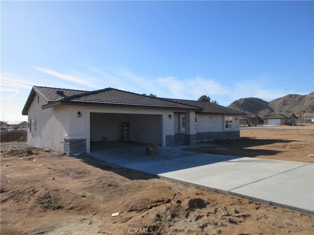 15729 Sago Road Apple Valley, CA 92307 - Photo 1 of 1 a view of a house with a yard
