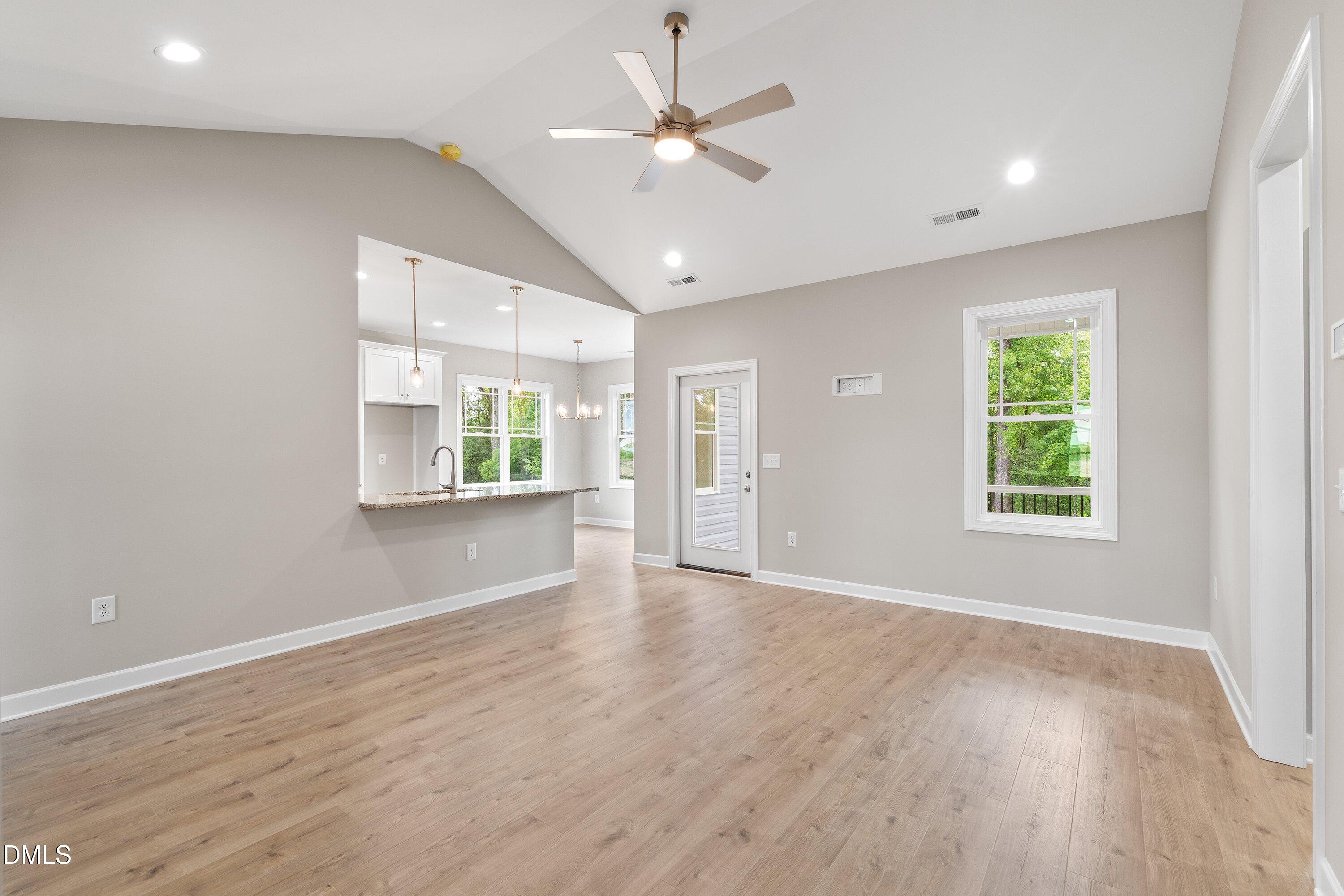 1115 Nor-Am Road Pikeville, NC 27863 - Photo 9 of 40 wooden floor in an empty room with a window