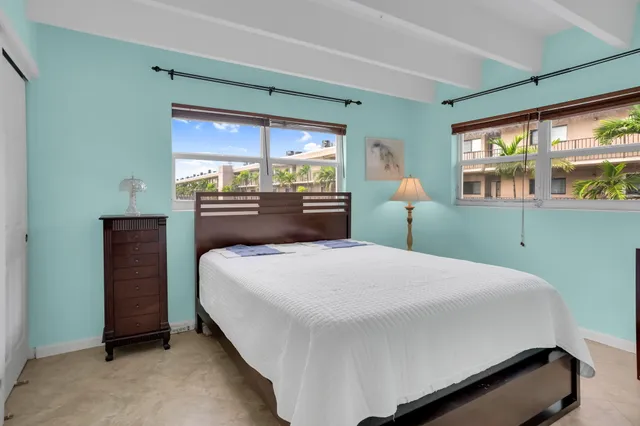 a bedroom with a large bed and a large window