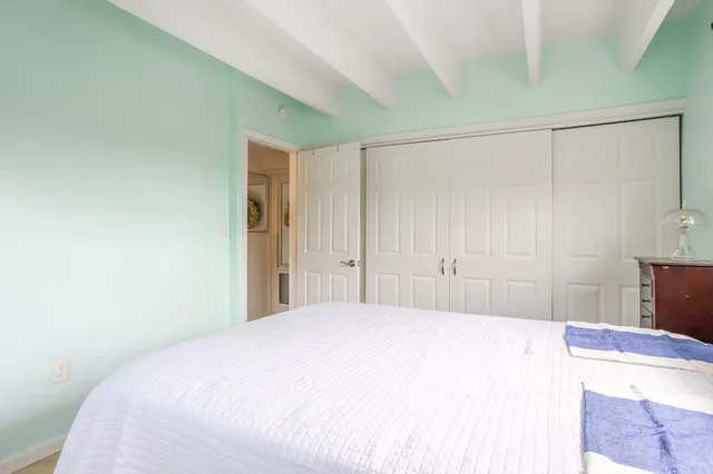 a bedroom with a bed and a mirror