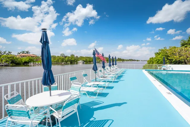 a view of a balcony with dining table and chairs with wooden floor