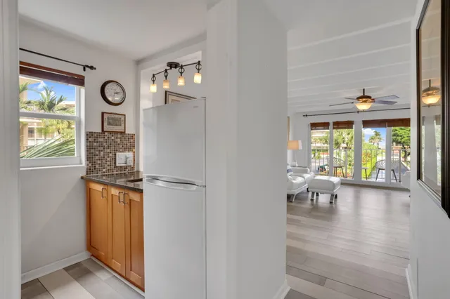 a view of dining room with wooden floor fan and windows