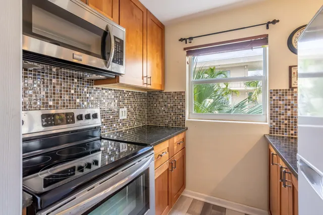 a kitchen with wooden cabinets and a stove top oven