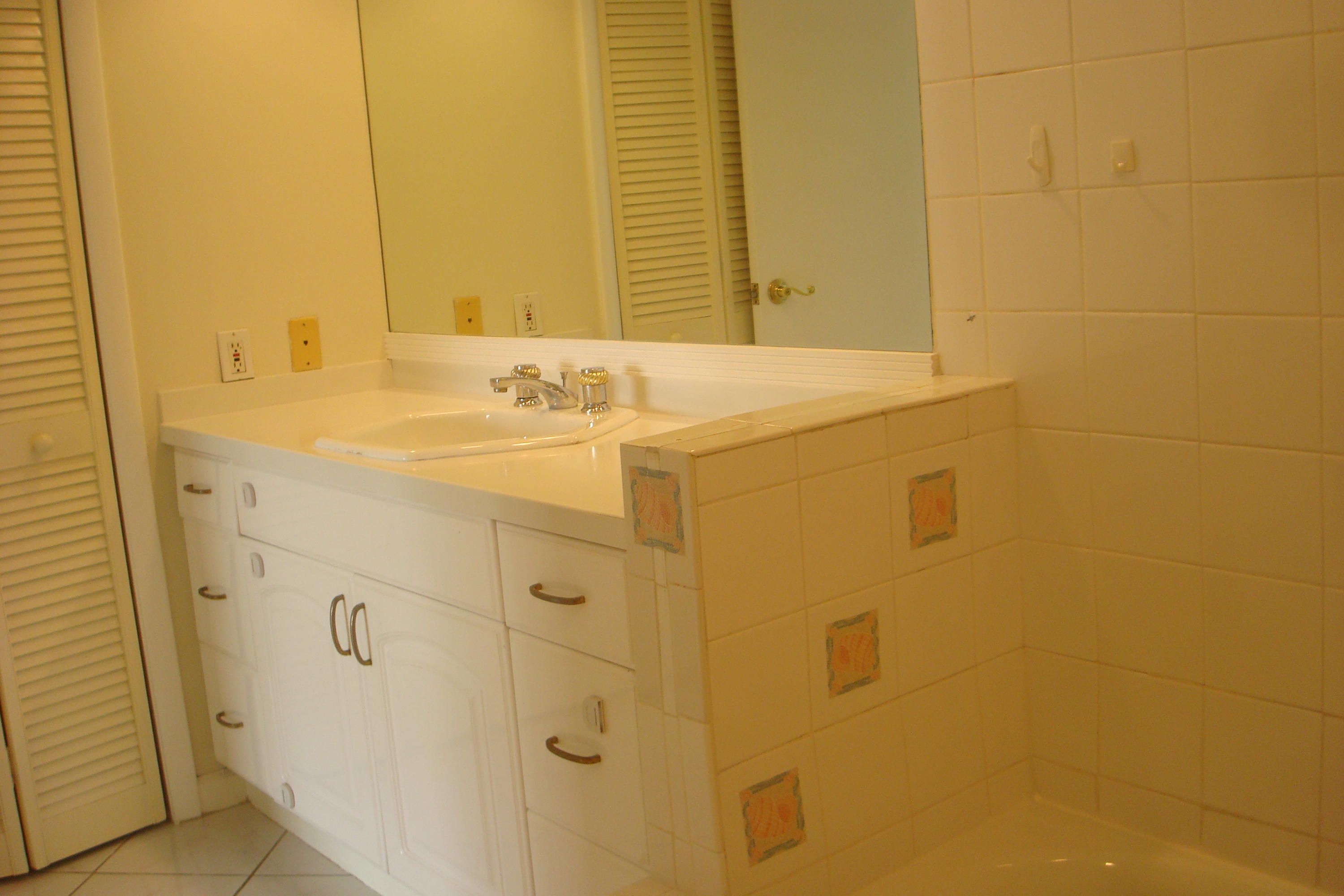 517 Dotterel Road, Unit 30A Delray Beach, FL 33444 - Photo 12 of 32 a bathroom with a sink and a mirror