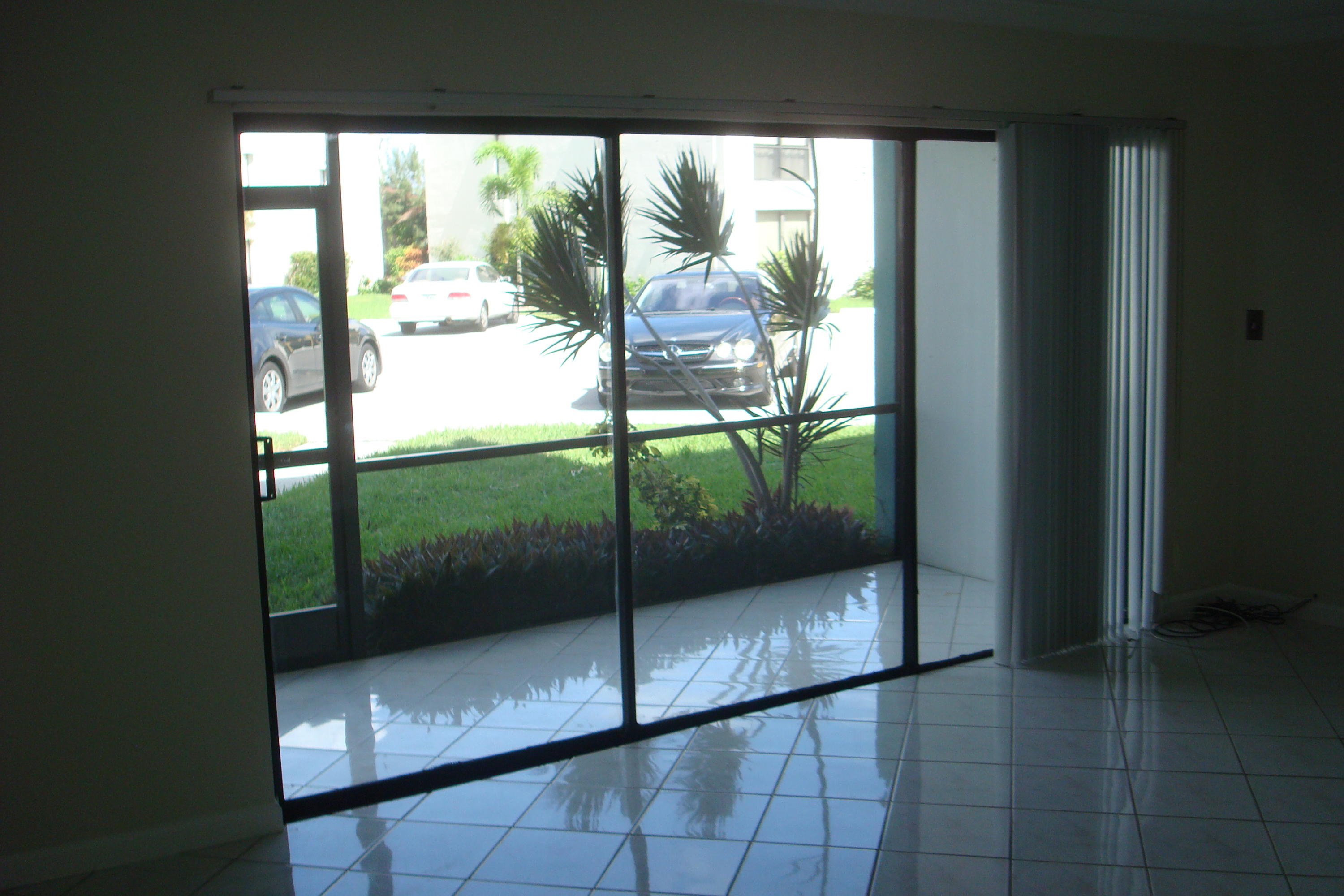 517 Dotterel Road, Unit 30A Delray Beach, FL 33444 - Photo 19 of 32 a view of a glass door and wooden floor
