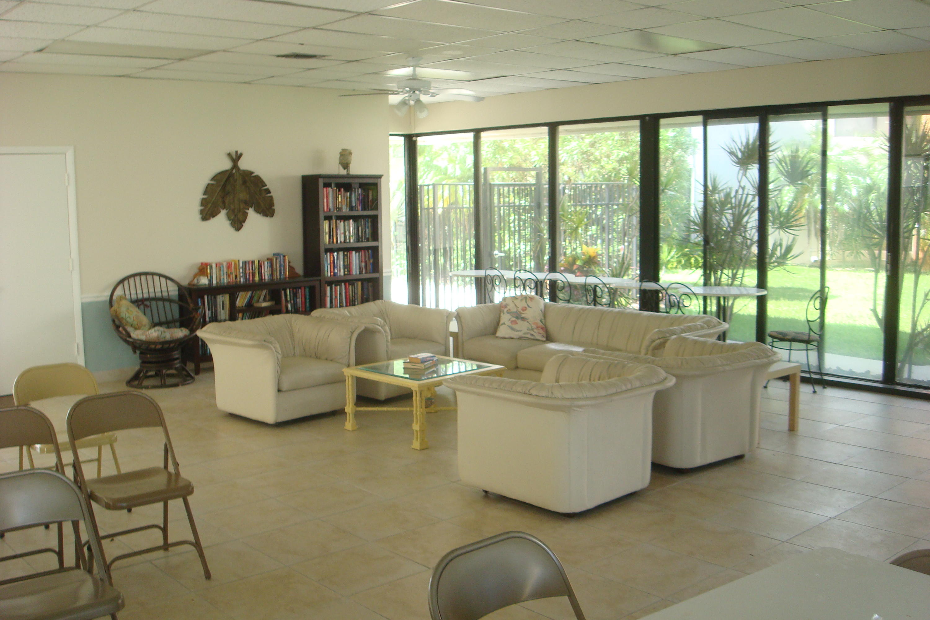 517 Dotterel Road, Unit 30A Delray Beach, FL 33444 - Photo 27 of 32 a living room with couches and a large window with garden view