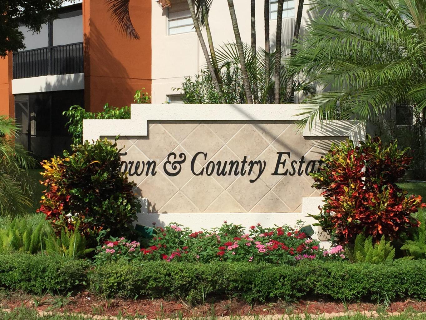 517 Dotterel Road, Unit 30A Delray Beach, FL 33444 - Photo 31 of 32 a sign that is sitting in front of flowers