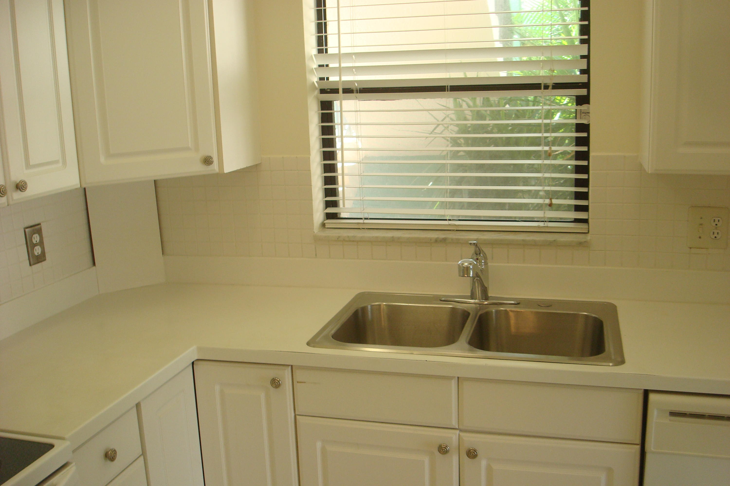 517 Dotterel Road, Unit 30A Delray Beach, FL 33444 - Photo 9 of 32 a kitchen with a sink and cabinets