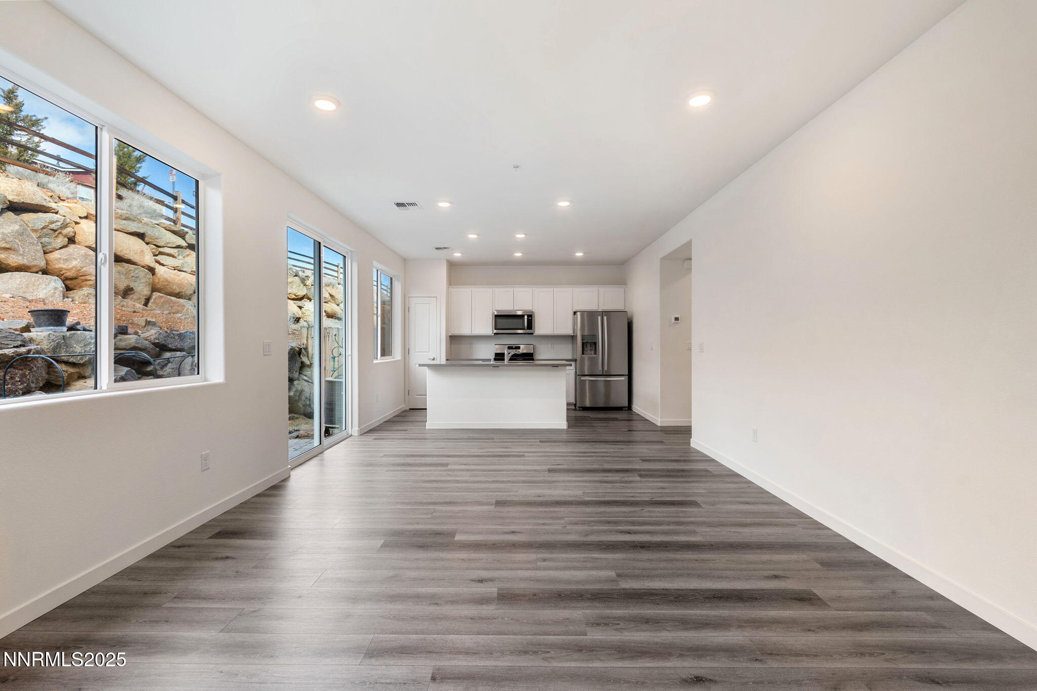 4589 Falcon Rock Lane Sun Valley, NV 89433 - Photo 12 of 26 a view of open kitchen with wooden floor and windows