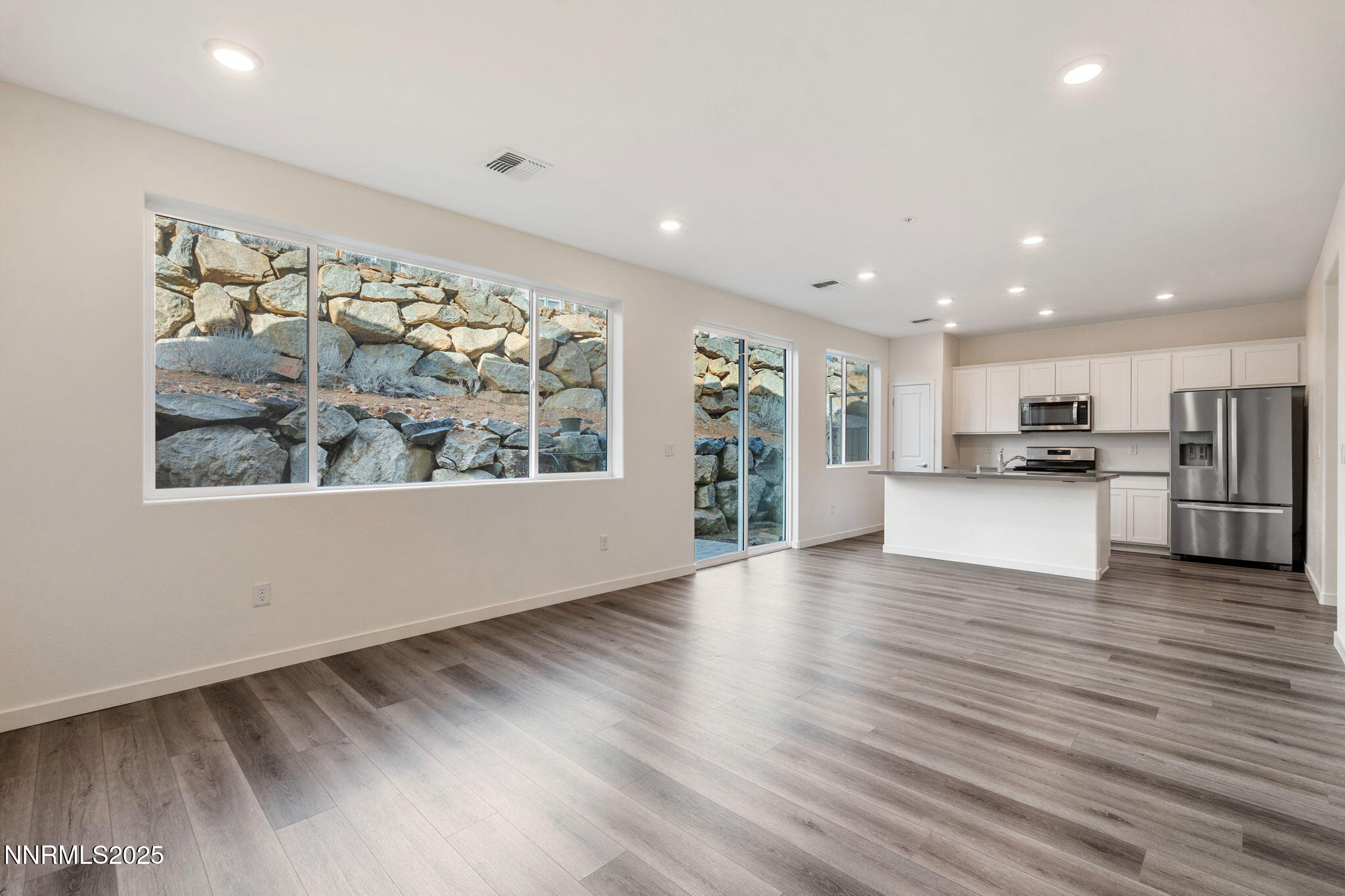 4589 Falcon Rock Lane Sun Valley, NV 89433 - Photo 14 of 26 a view of kitchen with stainless steel appliances kitchen island wooden floor and window