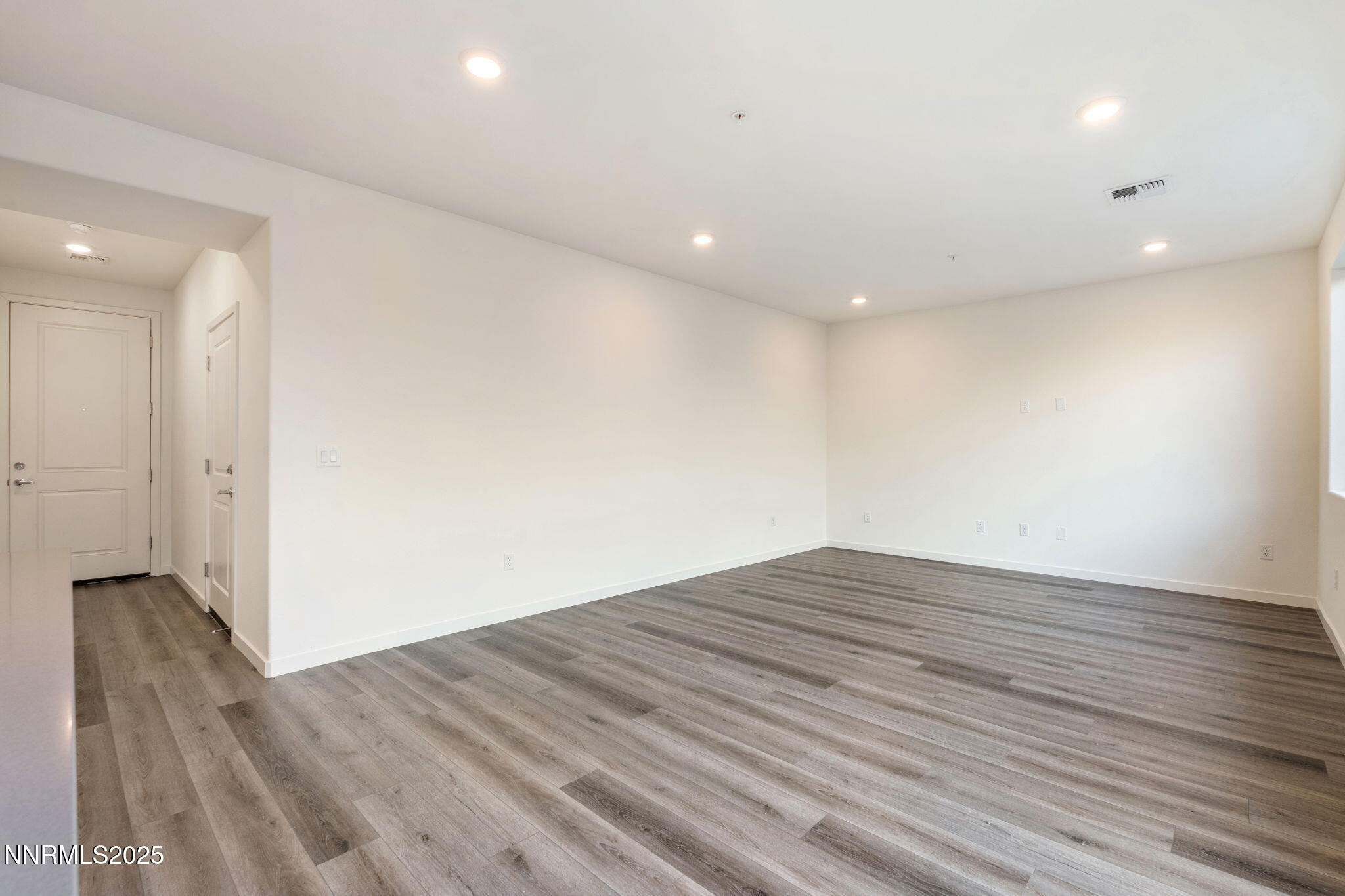 4589 Falcon Rock Lane Sun Valley, NV 89433 - Photo 15 of 26 a view of empty room with wooden floor