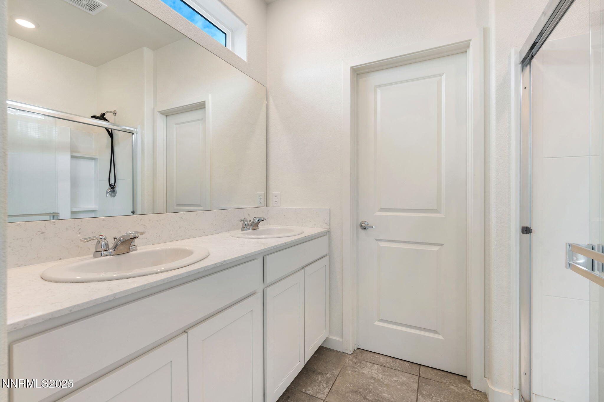 4589 Falcon Rock Lane Sun Valley, NV 89433 - Photo 20 of 26 a bathroom with a sink and a mirror
