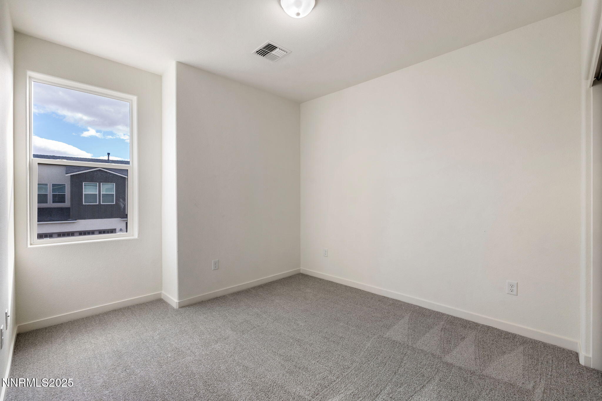 4589 Falcon Rock Lane Sun Valley, NV 89433 - Photo 21 of 26 an empty room with windows and entrance