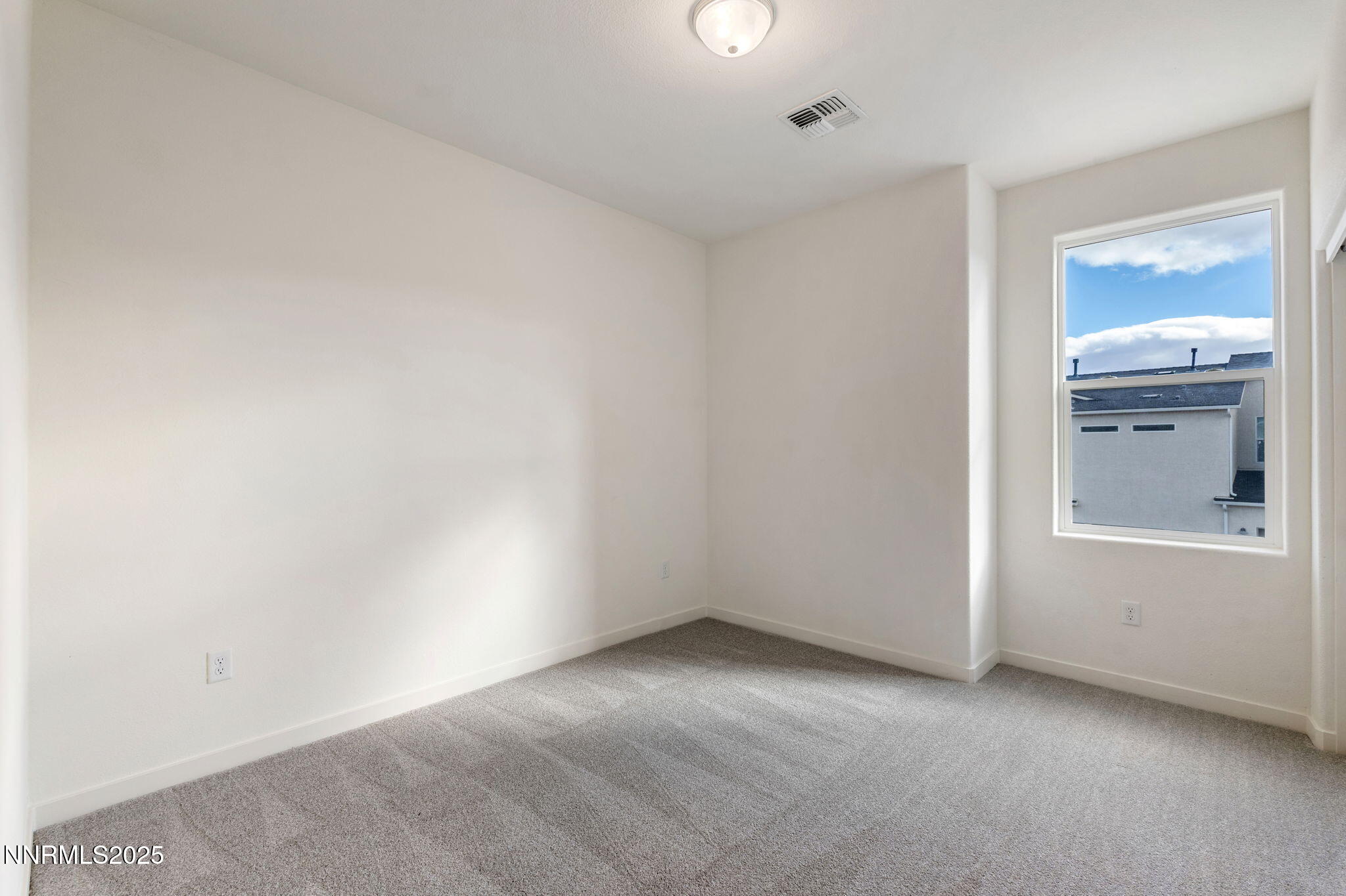 4589 Falcon Rock Lane Sun Valley, NV 89433 - Photo 22 of 26 an empty room with windows