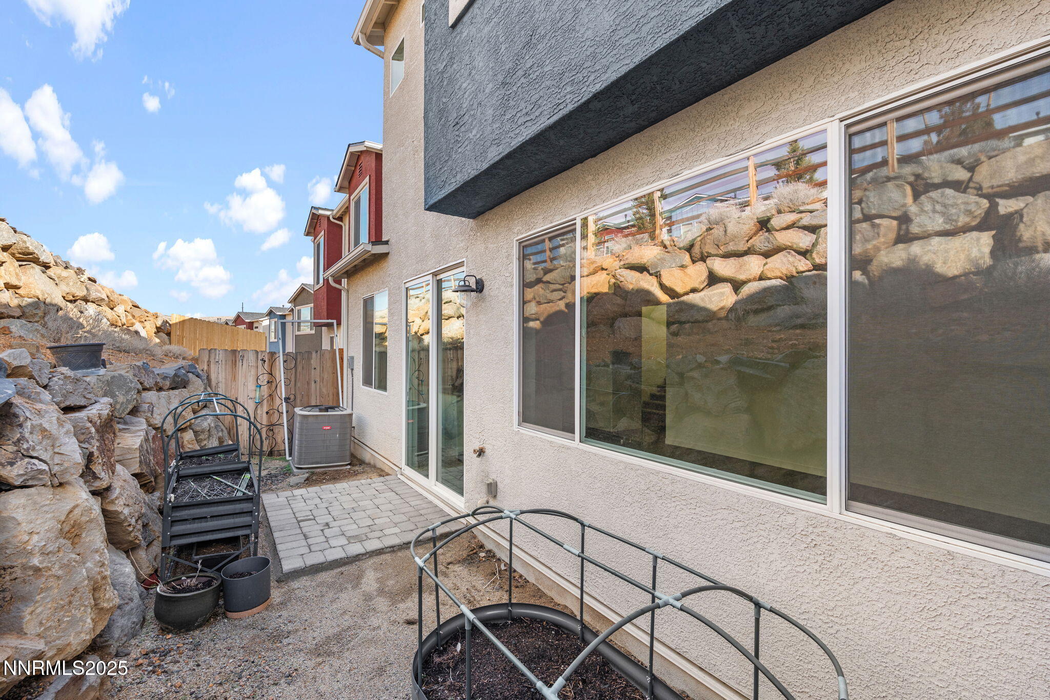 4589 Falcon Rock Lane Sun Valley, NV 89433 - Photo 25 of 26 a view of a patio with table and chairs and potted plants