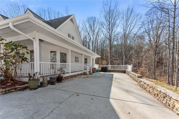 a view of a house with a yard covered in snow