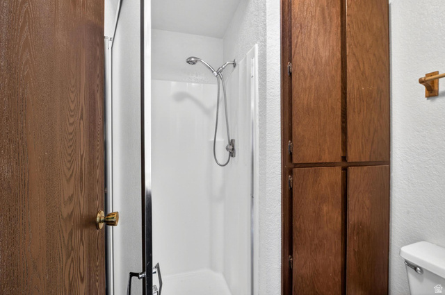 407 South Vasels Road, Unit 24 Brian Head, UT 84719 - Photo 16 of 63 Full bathroom featuring a textured wall and a stall shower