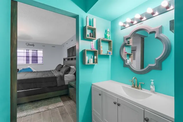 a bathroom with a sink mirror and vanity