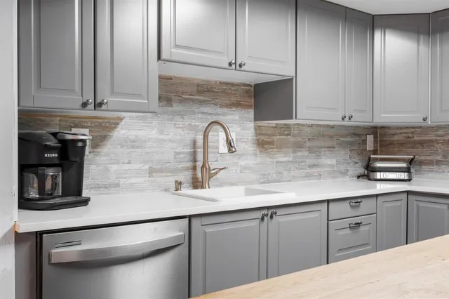 a kitchen with stainless steel appliances granite countertop a sink a stove and cabinets