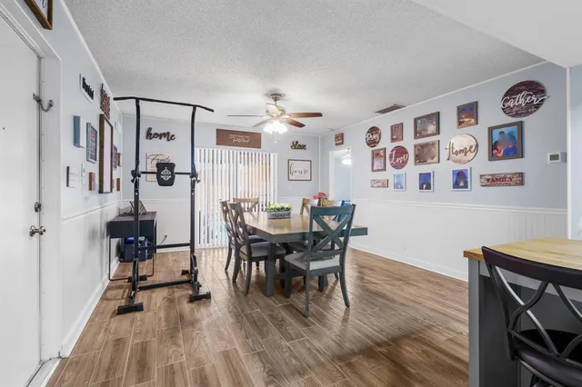 a view of a dining room with furniture and wooden floor