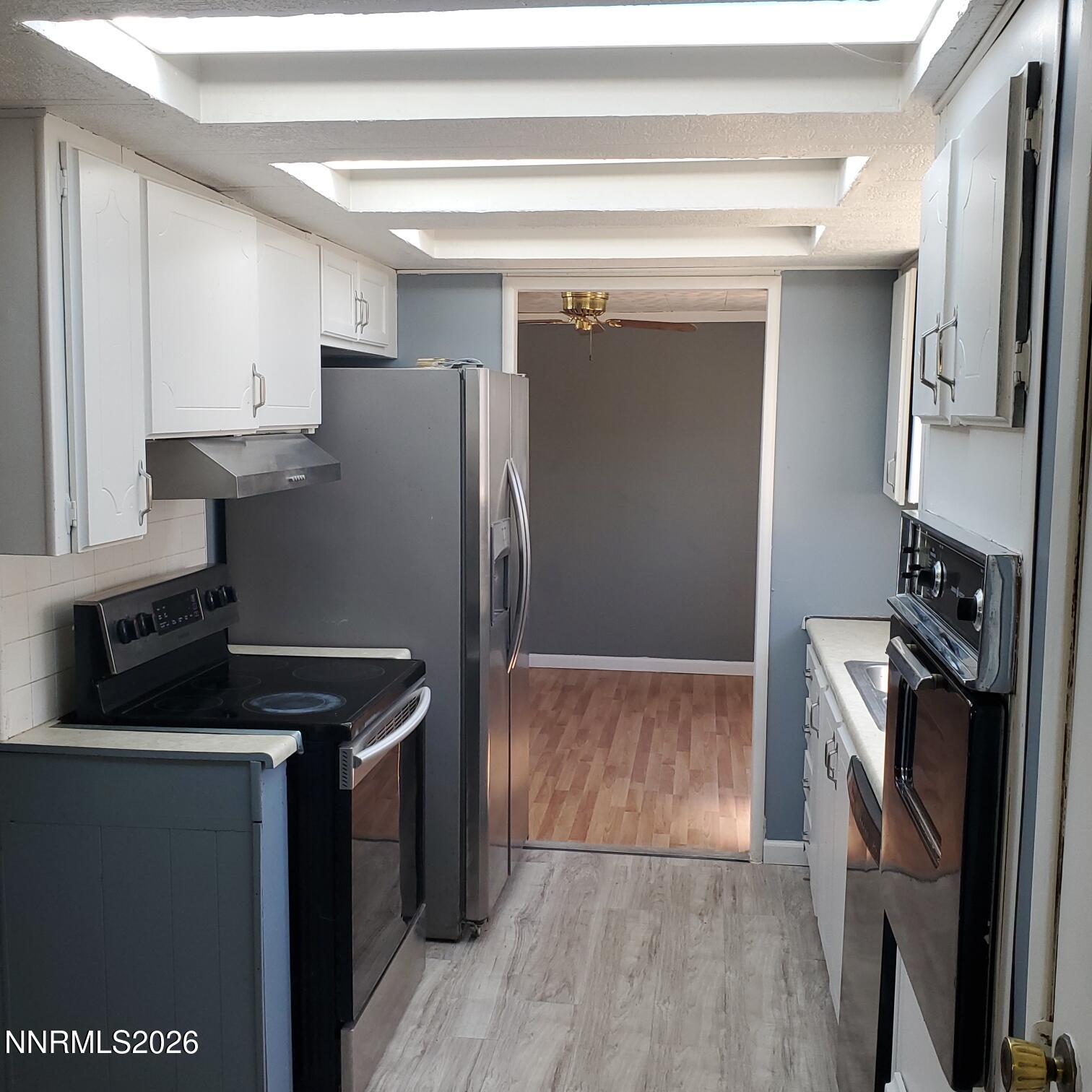 440 N Street Hawthorne, NV 89415 - Photo 14 of 34 a kitchen with metallic refrigerator and a stove