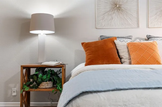 a bedroom with a large bed and a chandelier