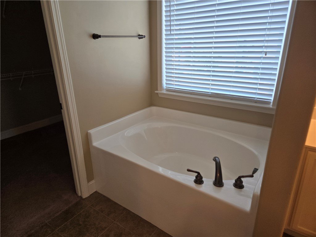 304 Knoll View Drive Seneca, SC 29678 - Photo 11 of 36 Relax in this inviting tub, featuring a window and tiled flooring.