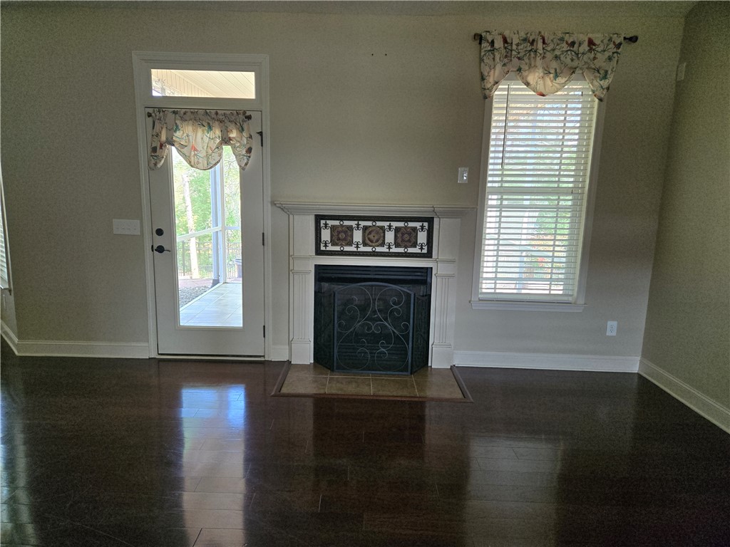 304 Knoll View Drive Seneca, SC 29678 - Photo 15 of 36 This inviting space features a charming fireplace, rich hardwood floors, and abundant natural light.