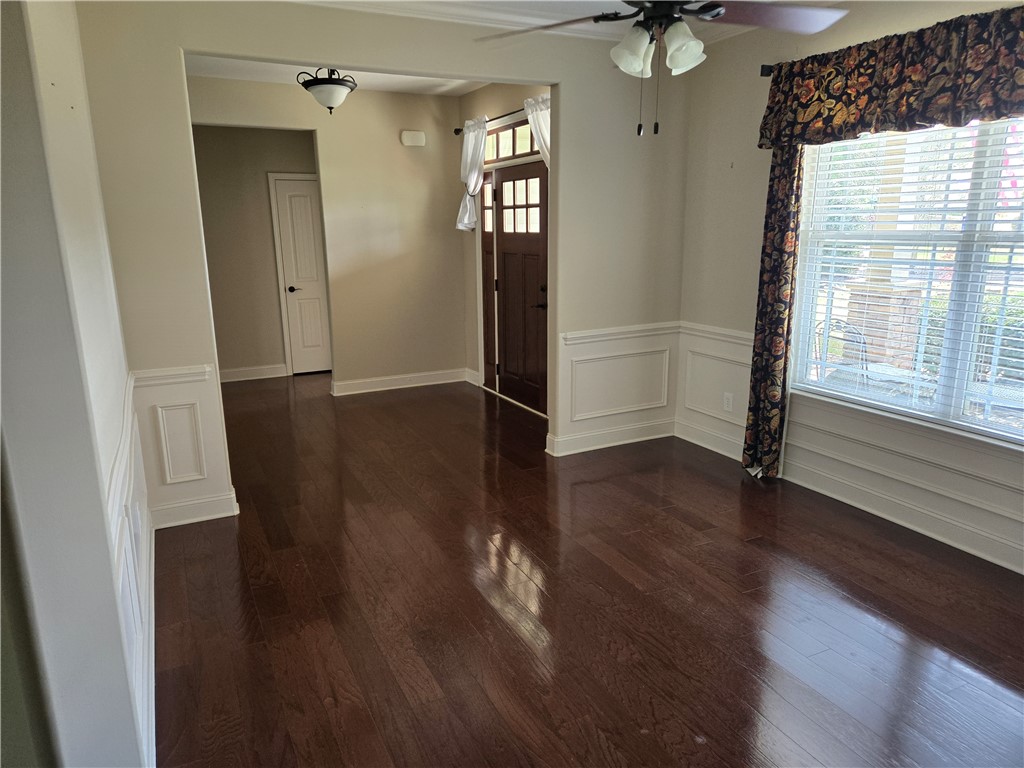 304 Knoll View Drive Seneca, SC 29678 - Photo 2 of 36 This inviting room features rich wood flooring, elegant wainscoting, and a prominent front door.