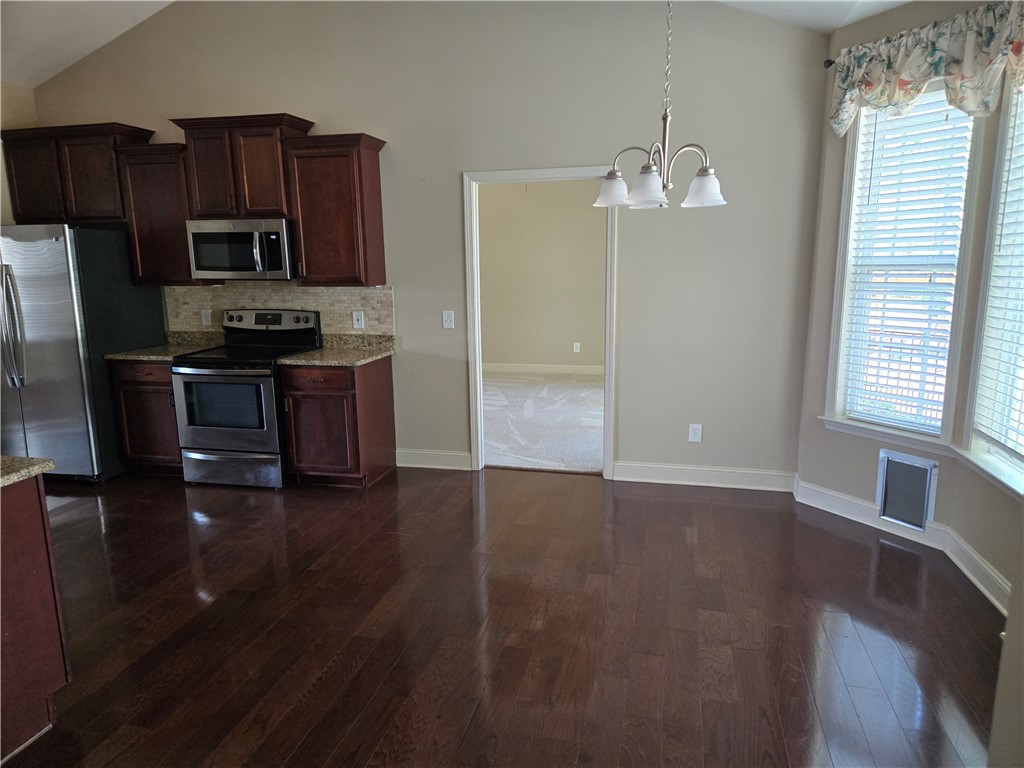 304 Knoll View Drive Seneca, SC 29678 - Photo 5 of 36 This inviting dining area features elegant hardwood floors and a convenient pass-through to an adjoining room.