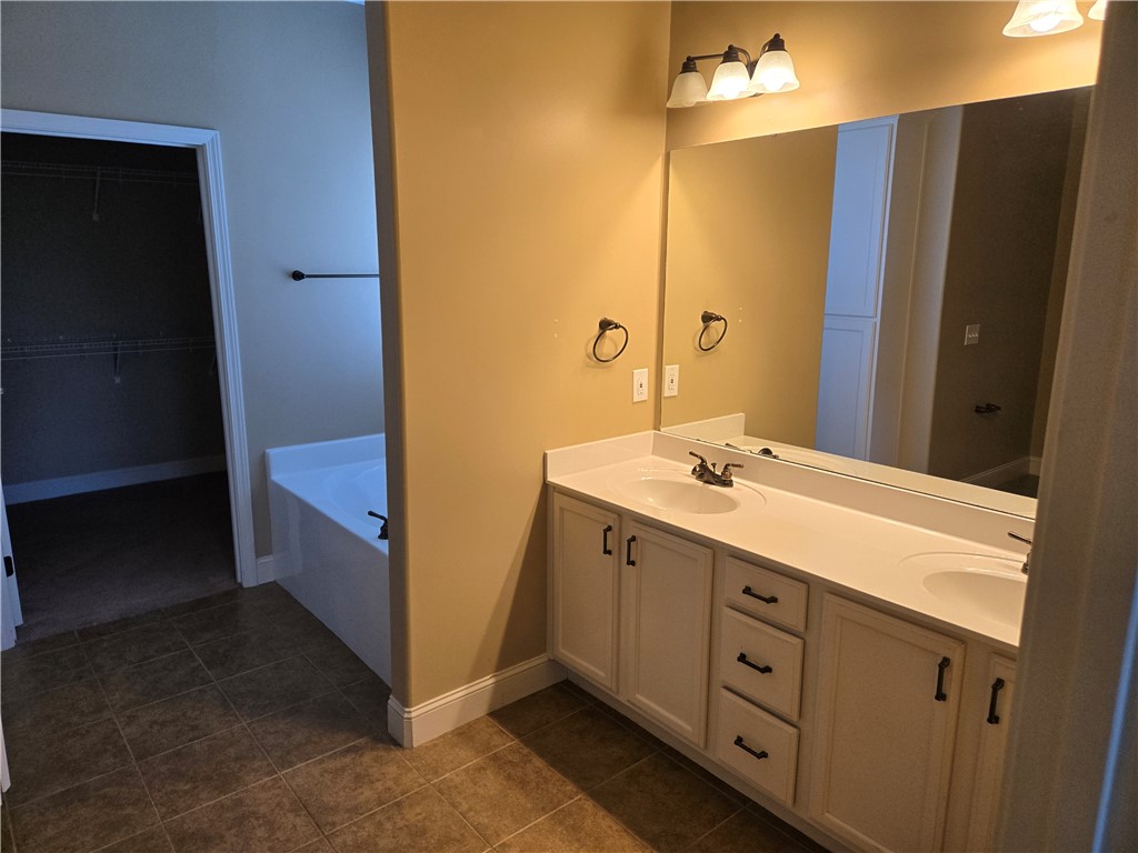 304 Knoll View Drive Seneca, SC 29678 - Photo 10 of 36 This bathroom features a double vanity and soaking tub, offering both comfort and practicality.